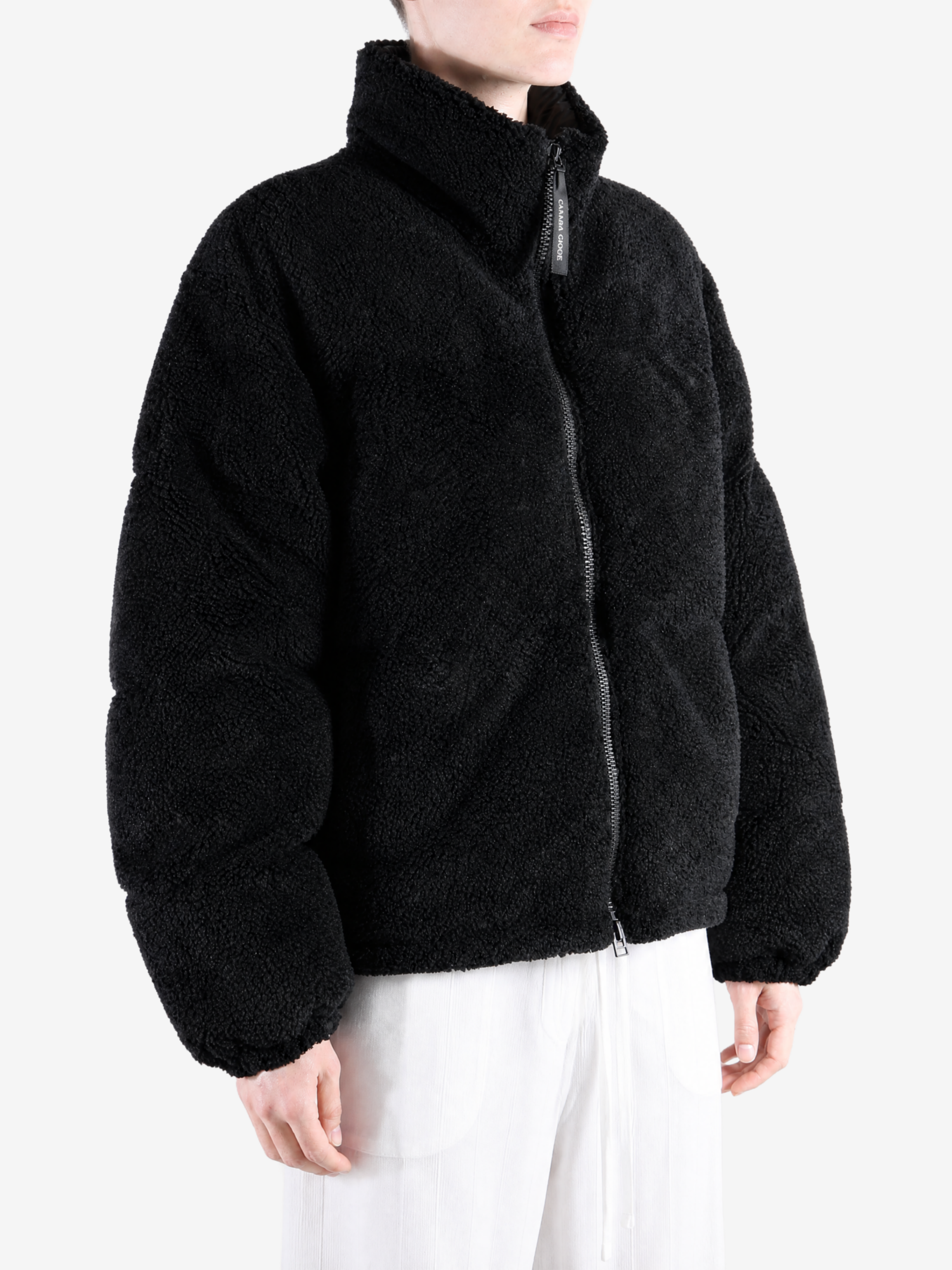 Black jacket worn by a person, showing the jacket fit