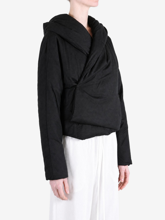Black jacket worn by a person, showing the jacket fit