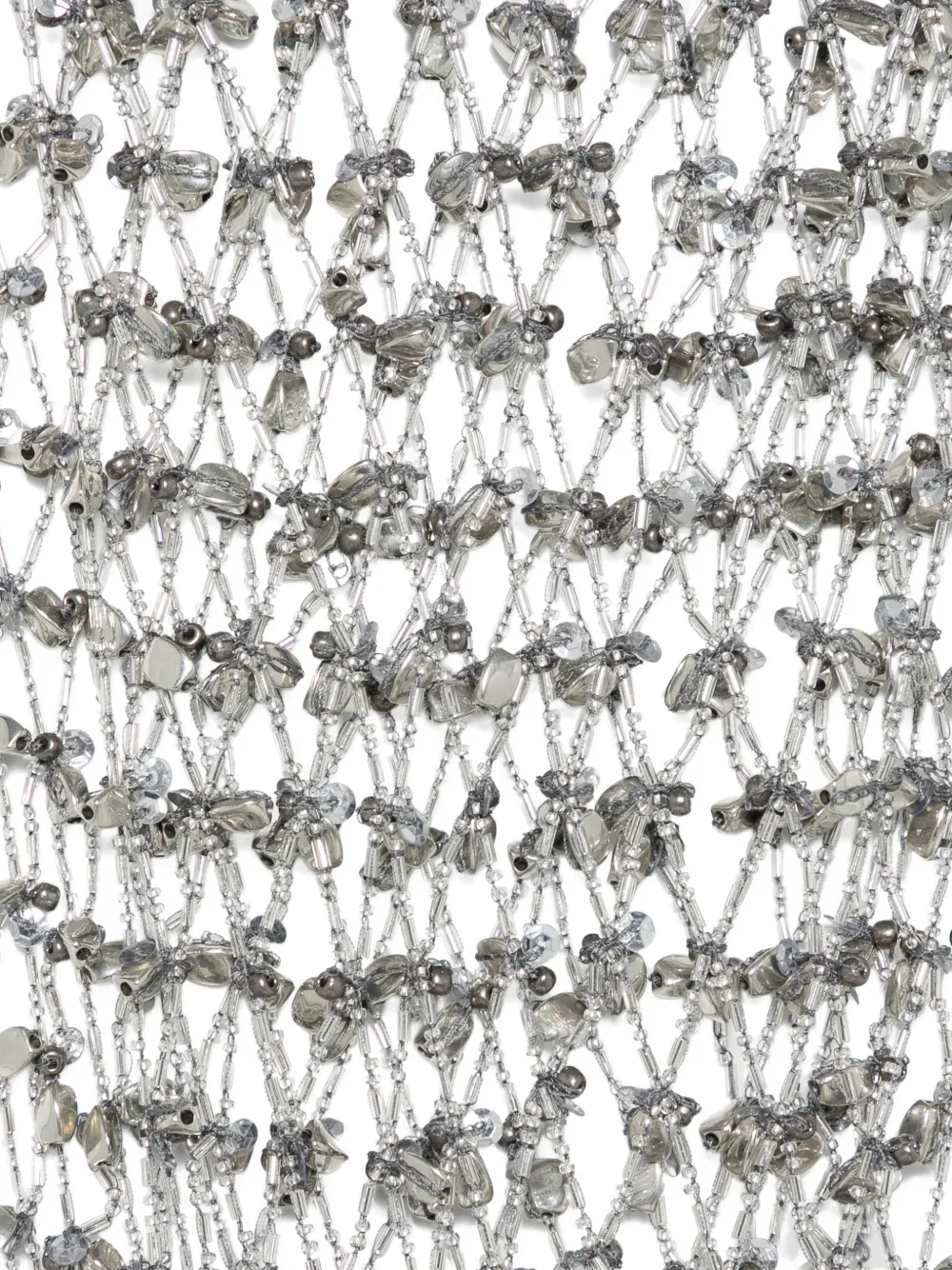 Close up of silver necklace, showing the detail of silver material