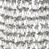 Close up of silver necklace, showing the detail of silver material