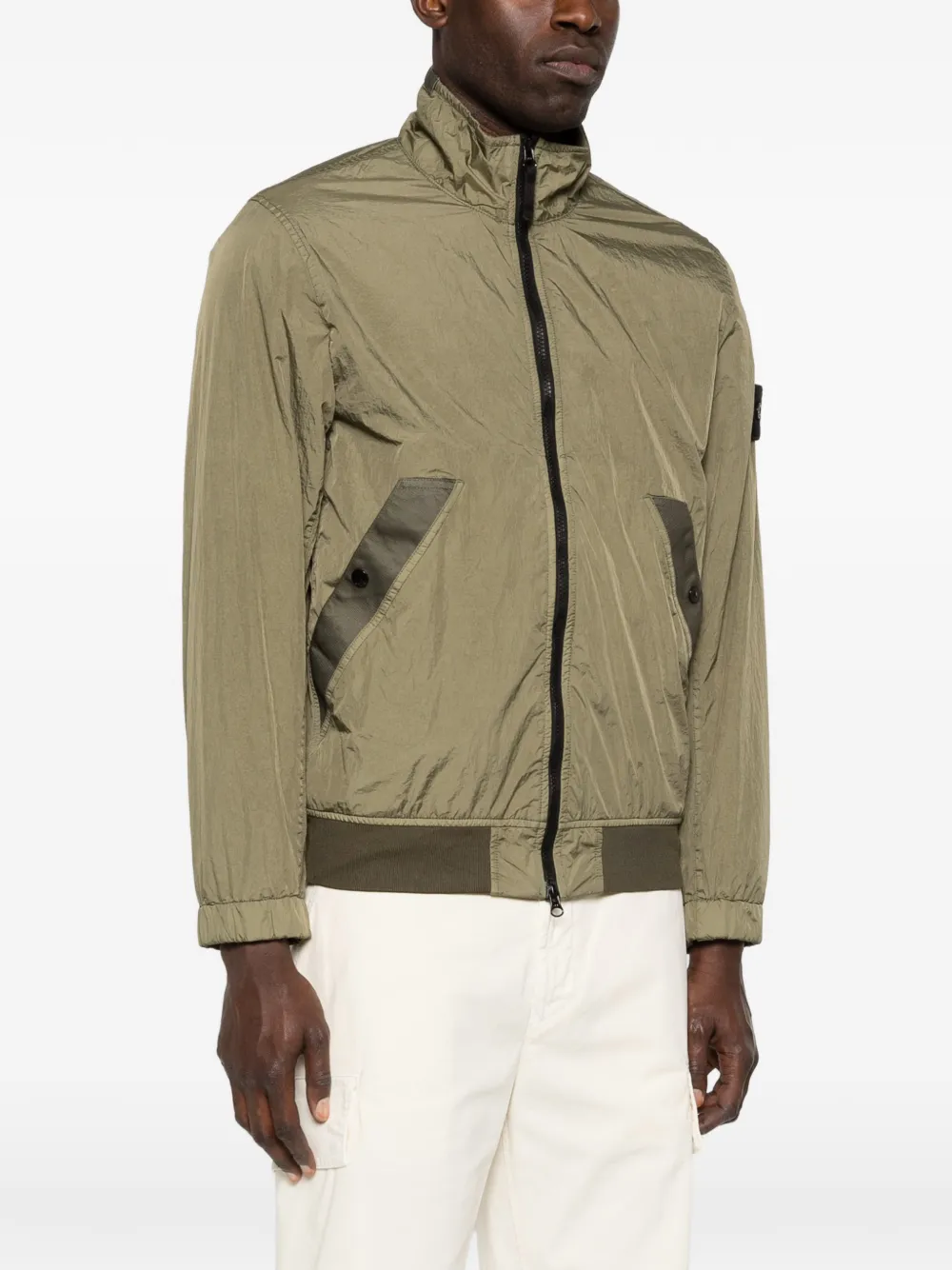 Green jackets worn by a person, showing the jackets fit