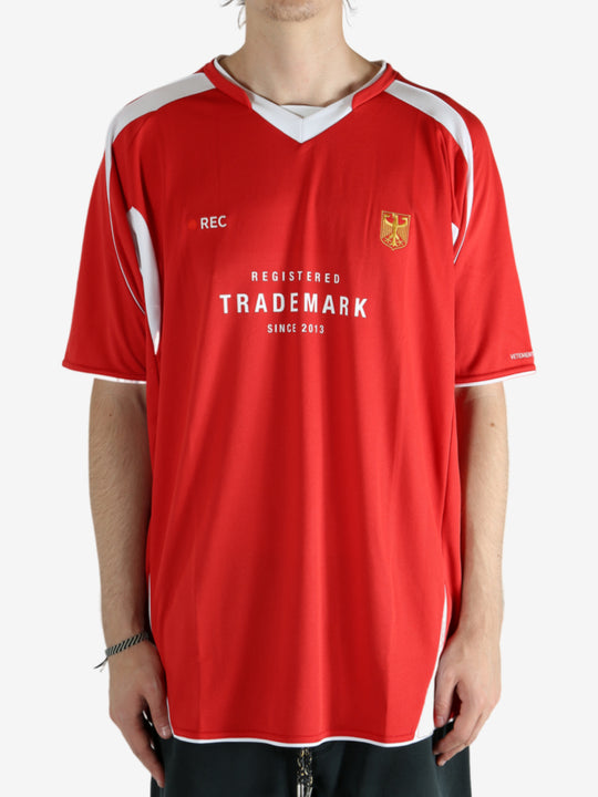 Red t-shirt worn by a person, showing the shirt's fit