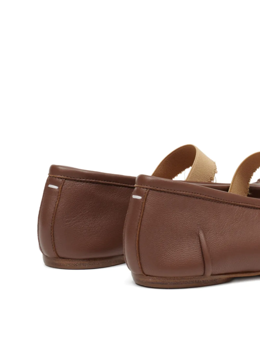 Close up of the brown flats, showing texture of the leather fabric