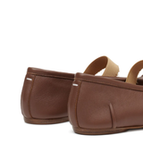 Close up of the brown flats, showing texture of the leather fabric