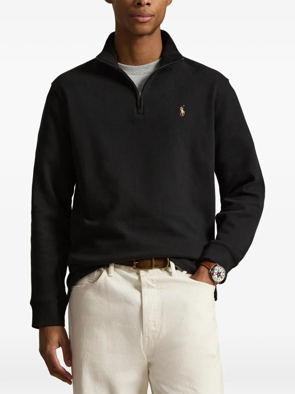 Black knitwear worn by a person, showing the knitwear fit