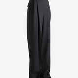 Black pants worn by a person, showing the pants fit