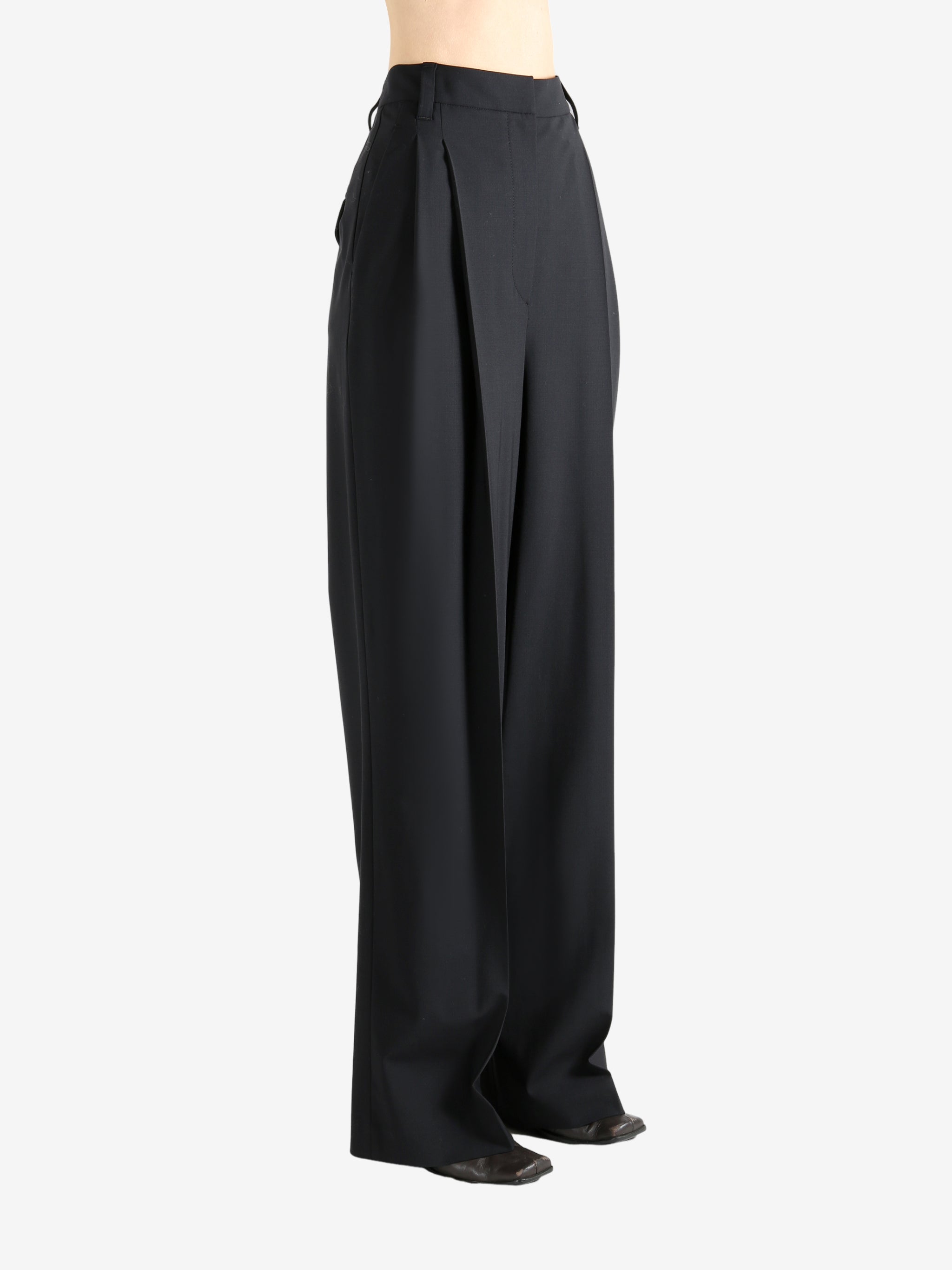 Black pants worn by a person, showing the pants fit