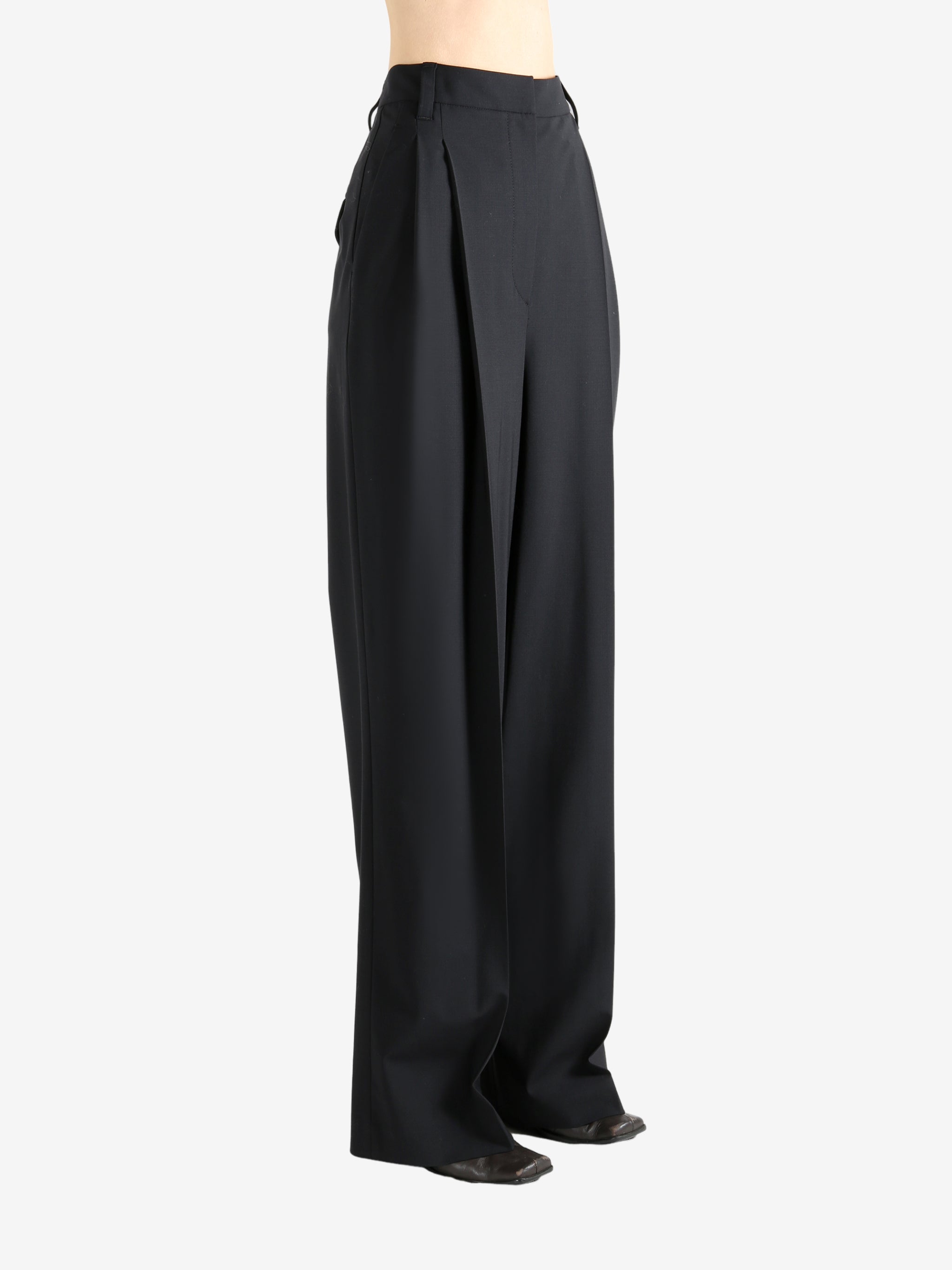 Black pants worn by a person, showing the pants fit