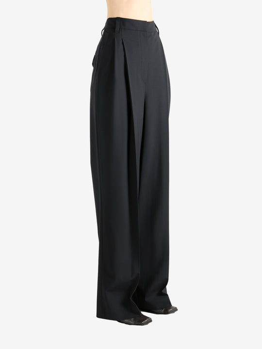 Black pants worn by a person, showing the pants fit