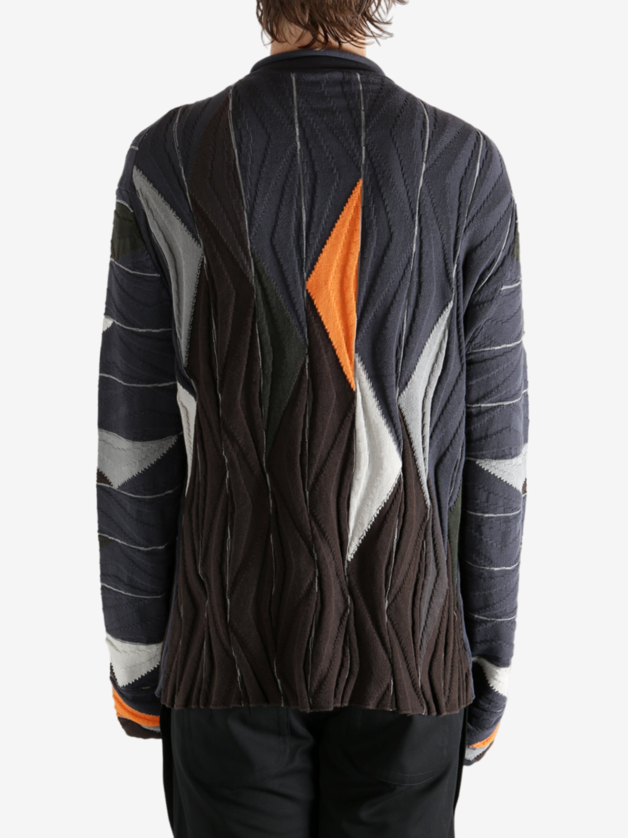 Brown top worn by a person, showing the top's fit