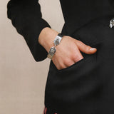 Grey accessories worn by a person, showing the accessories fit