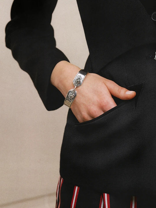 Grey accessories worn by a person, showing the accessories fit