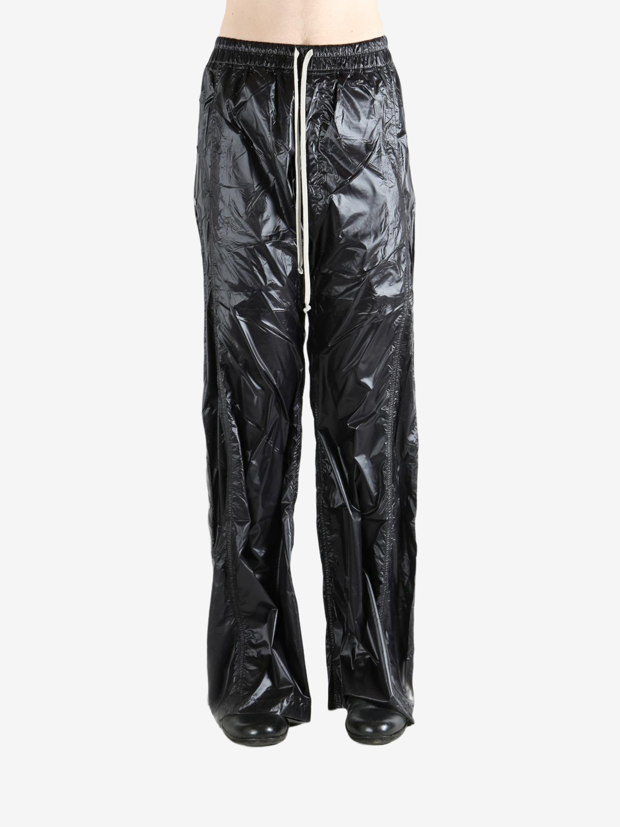 Black pants worn by a person, showing the pants' fit