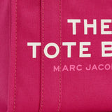 Close up of pink bag, showing brand logo