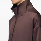 Close up of brown jacket, showing texture of the recycled polyester fabric