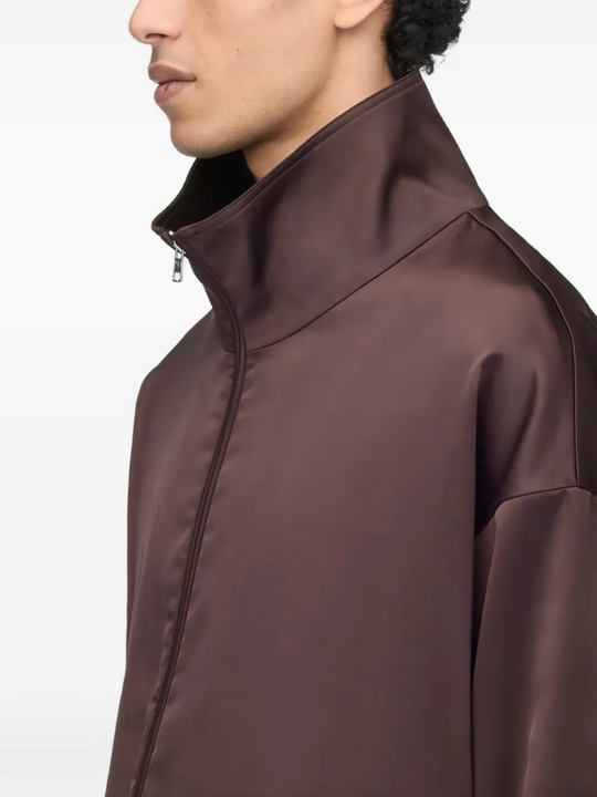 Close up of brown jacket, showing texture of the recycled polyester fabric