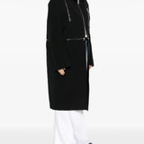 black jacket worn by a person, showing the jacket's fit
