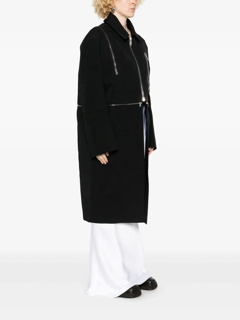 black jacket worn by a person, showing the jacket's fit
