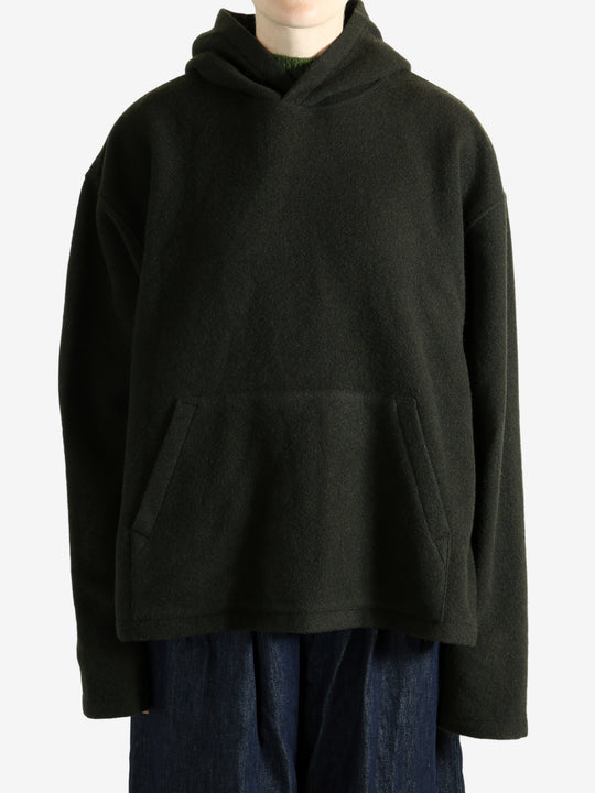 Green hoodie worn by a person, showing the hoodie's fit