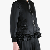 Black jacket worn by a person, showing the jacket's fit