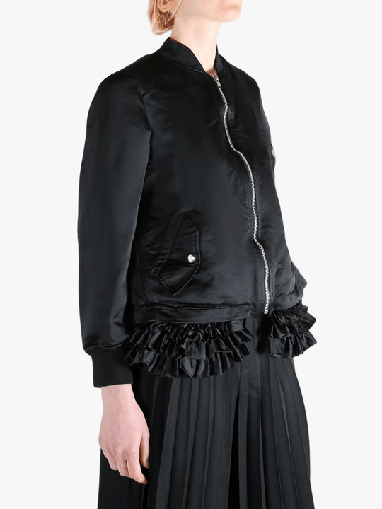 Black jacket worn by a person, showing the jacket's fit