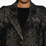 Close up of black jackets, showing texture of the fabric