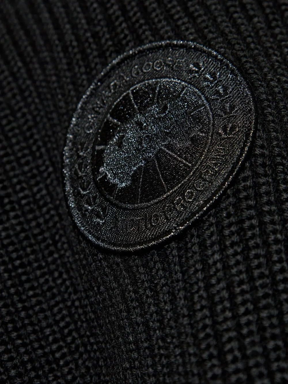 Close up of the black hoodie, showing texture of the polyamide fabric