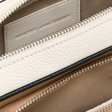 Close up of tan bags, showing texture of the split cow leather and polyurethane coating fabric
