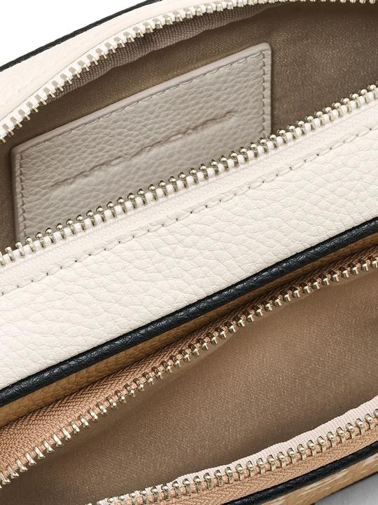 Close up of tan bags, showing texture of the split cow leather and polyurethane coating fabric