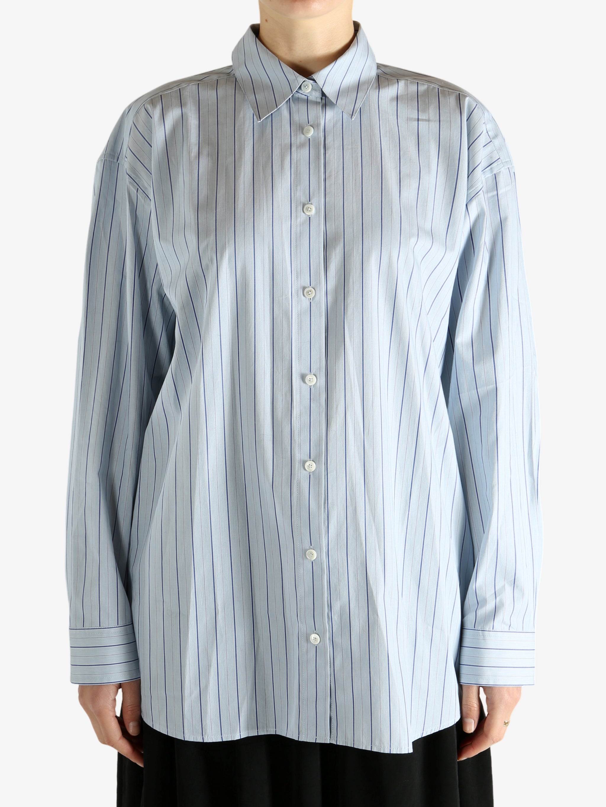 Blue shirts worn by a person, showing the shirts fit