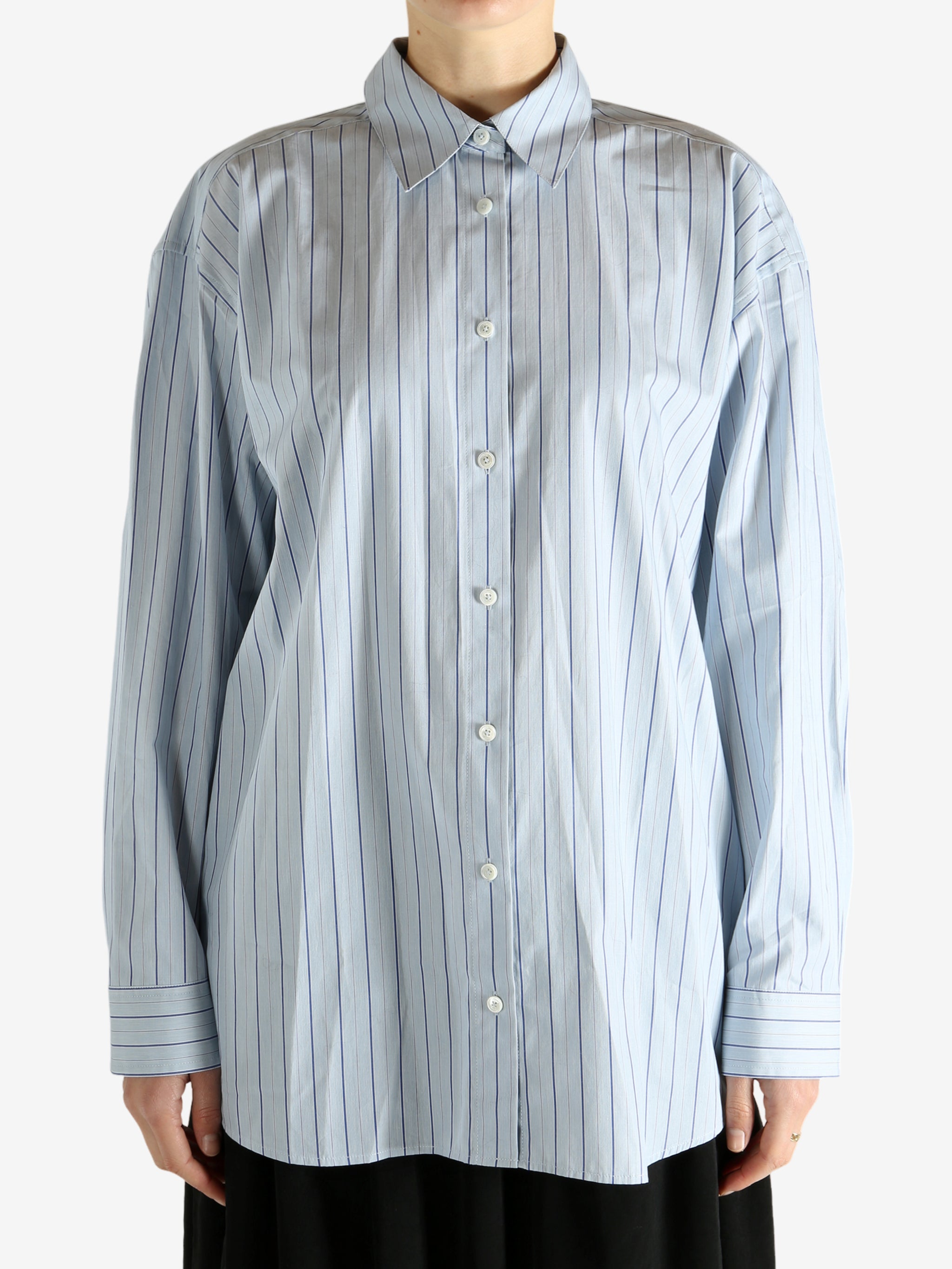 Blue shirts worn by a person, showing the shirts fit