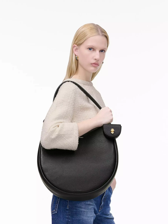 Black bag worn by a person, showing the bag's fit