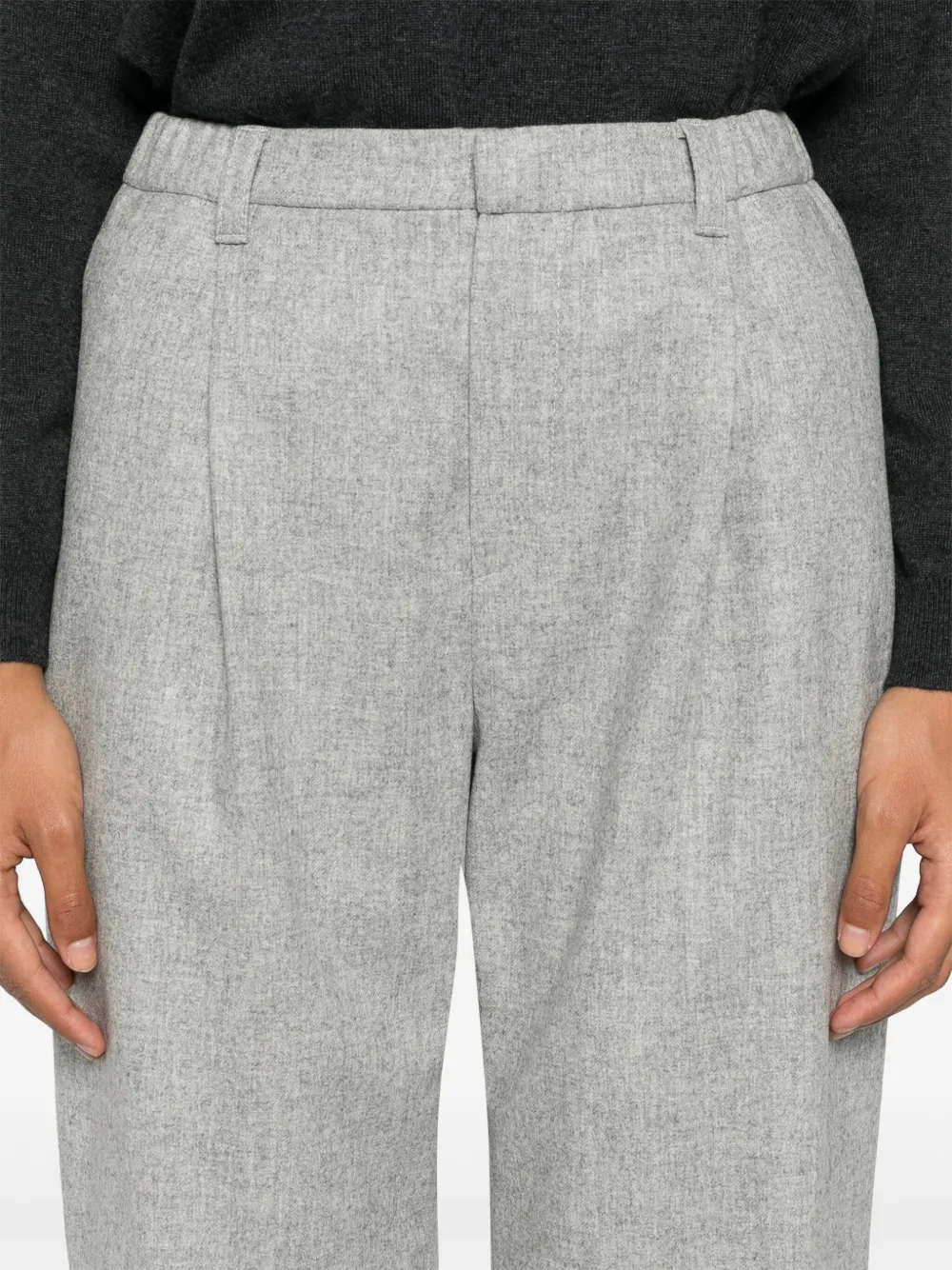 Grey pants worn by a person, showing the pants fit
