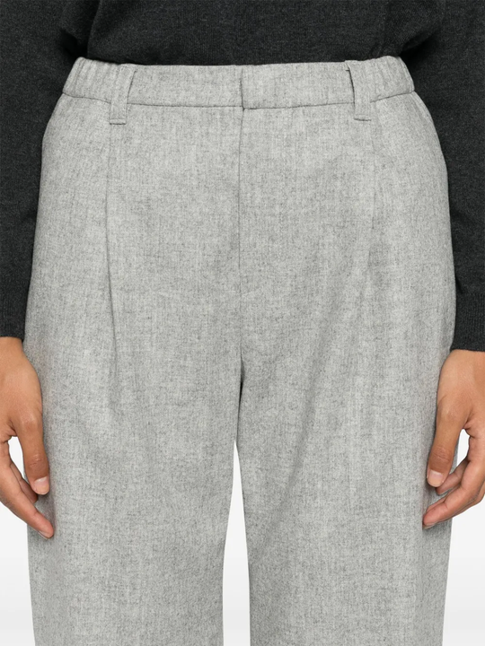 Grey pants worn by a person, showing the pants fit