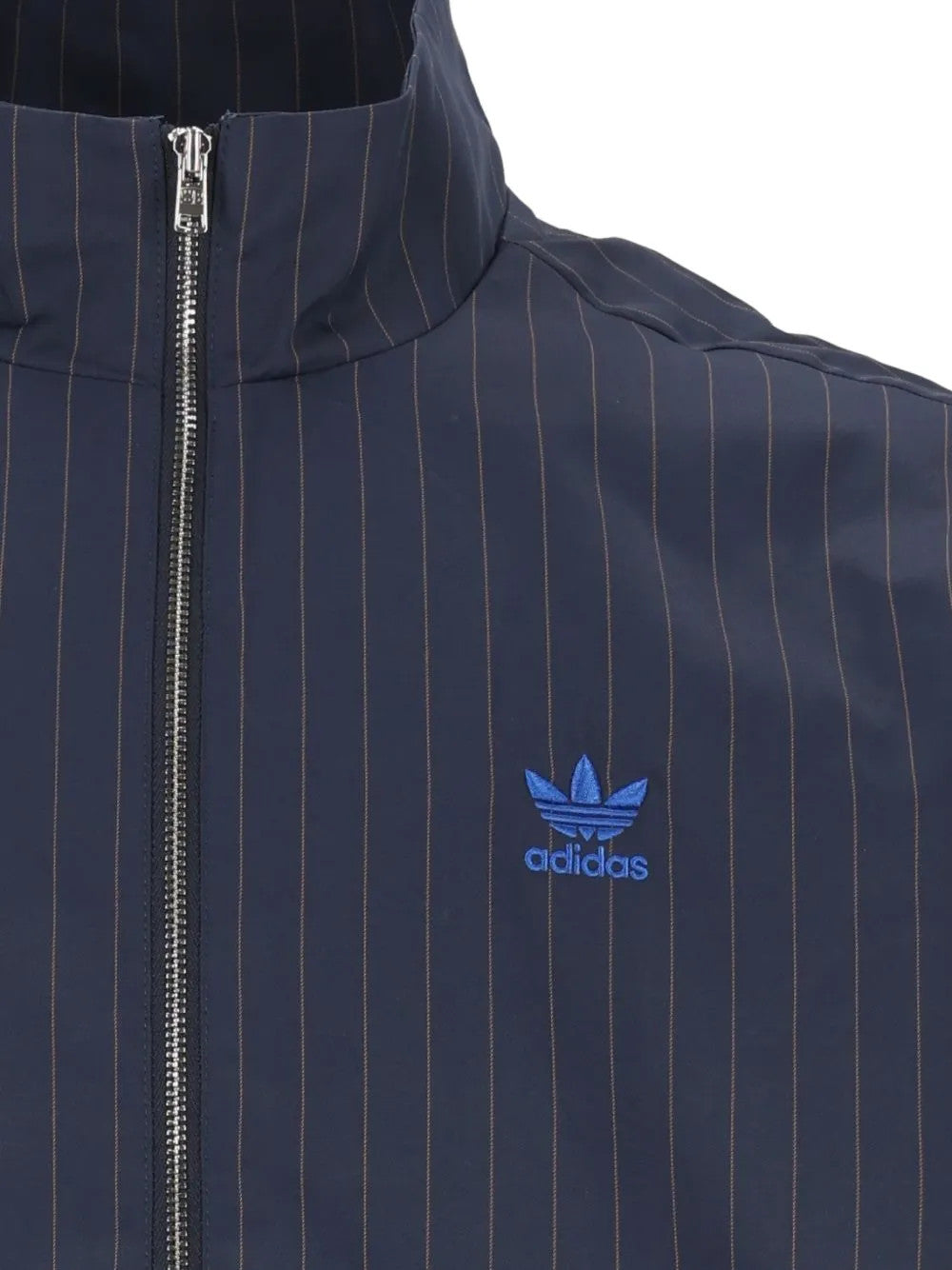 Close up of Navy jacket, showing texture of the 88% recycled polyester/ 12% polyester made in fabric