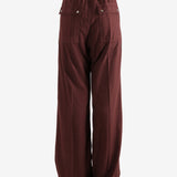 Burgundy pants worn by a person, showing the pants fit