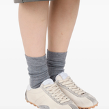 tan sneakers worn by a person, showing the sneakers fit