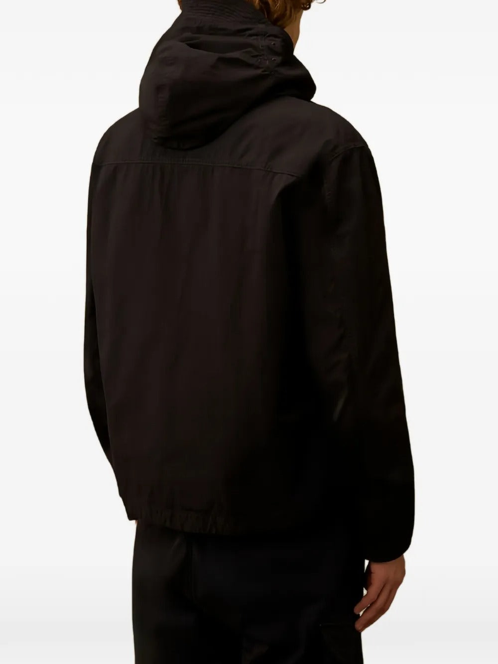 Black jacket worn by a person, showing the jacket's fit