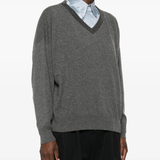 Grey knitwears worn by a person, showing the knitwears fit