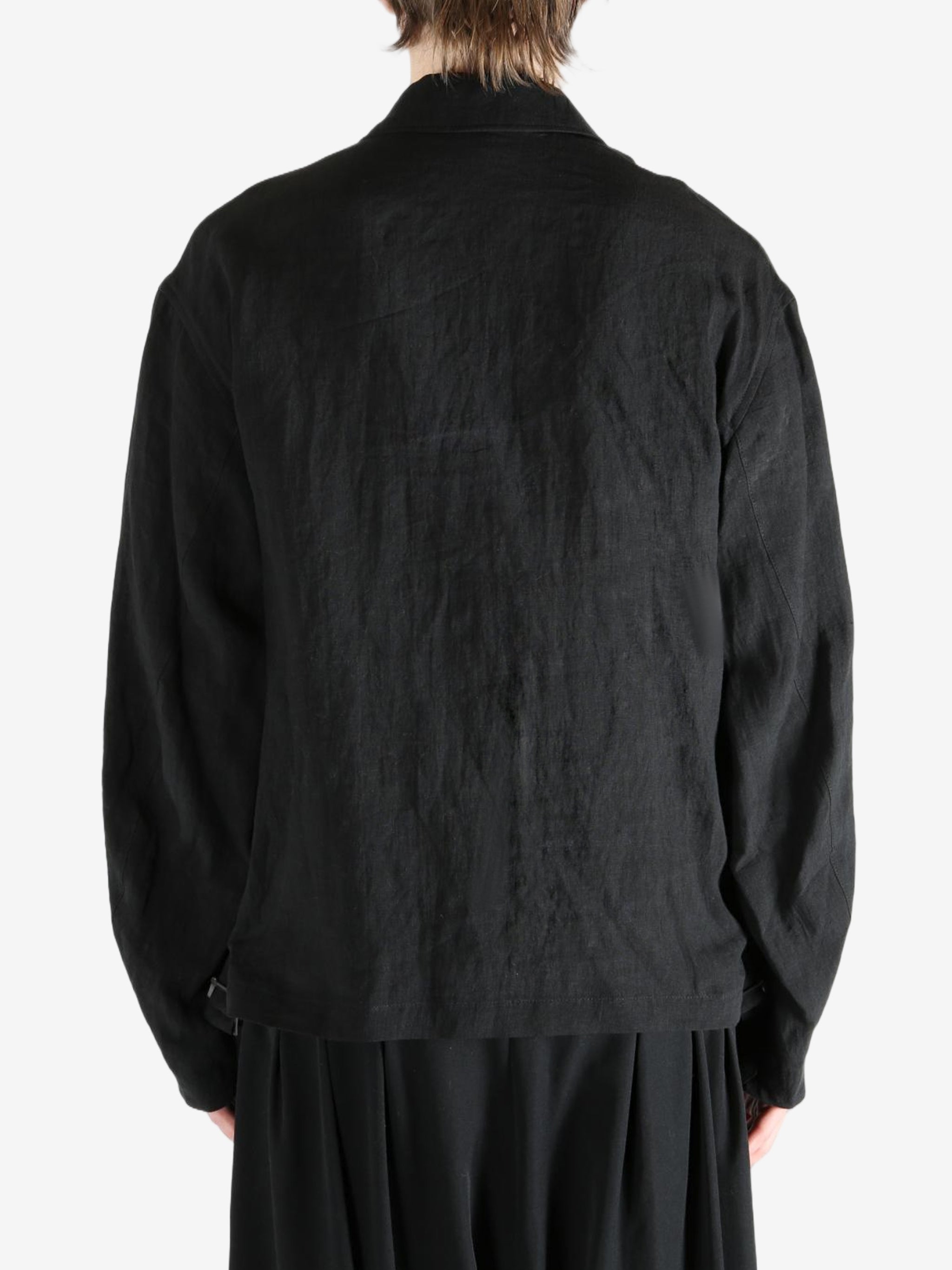 Black jacket worn by a person, showing the jacket's fit