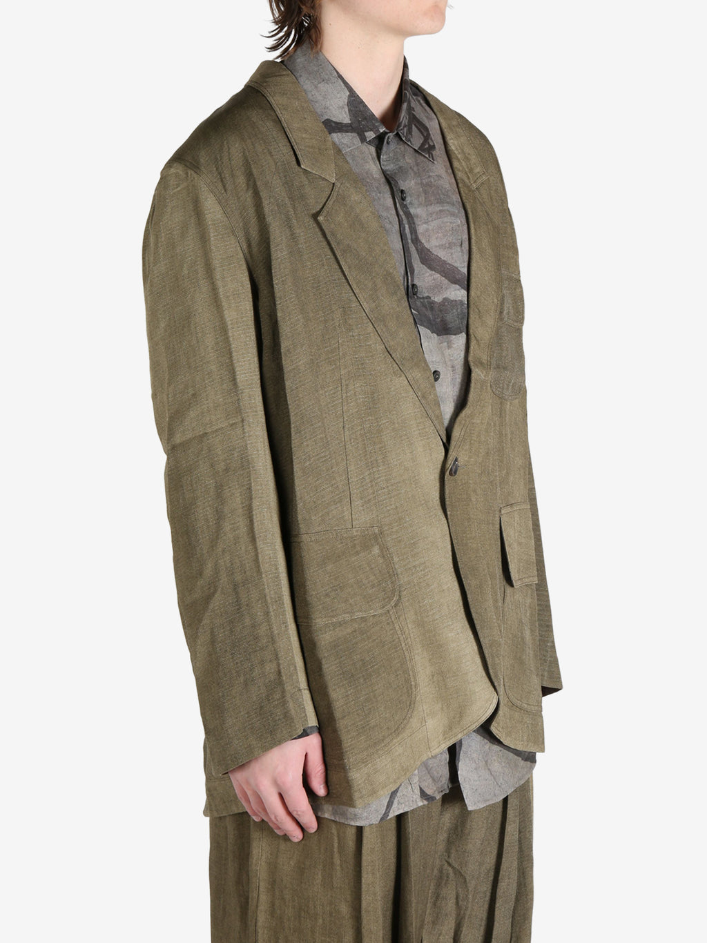 Green jacket worn by a person, showing the jacket's fit