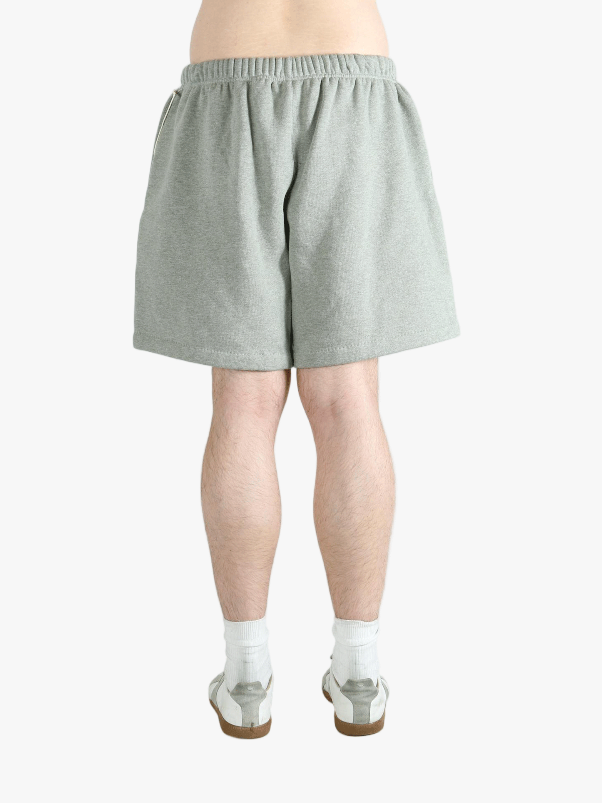 Gray shorts worn by a person, showing the short fit 