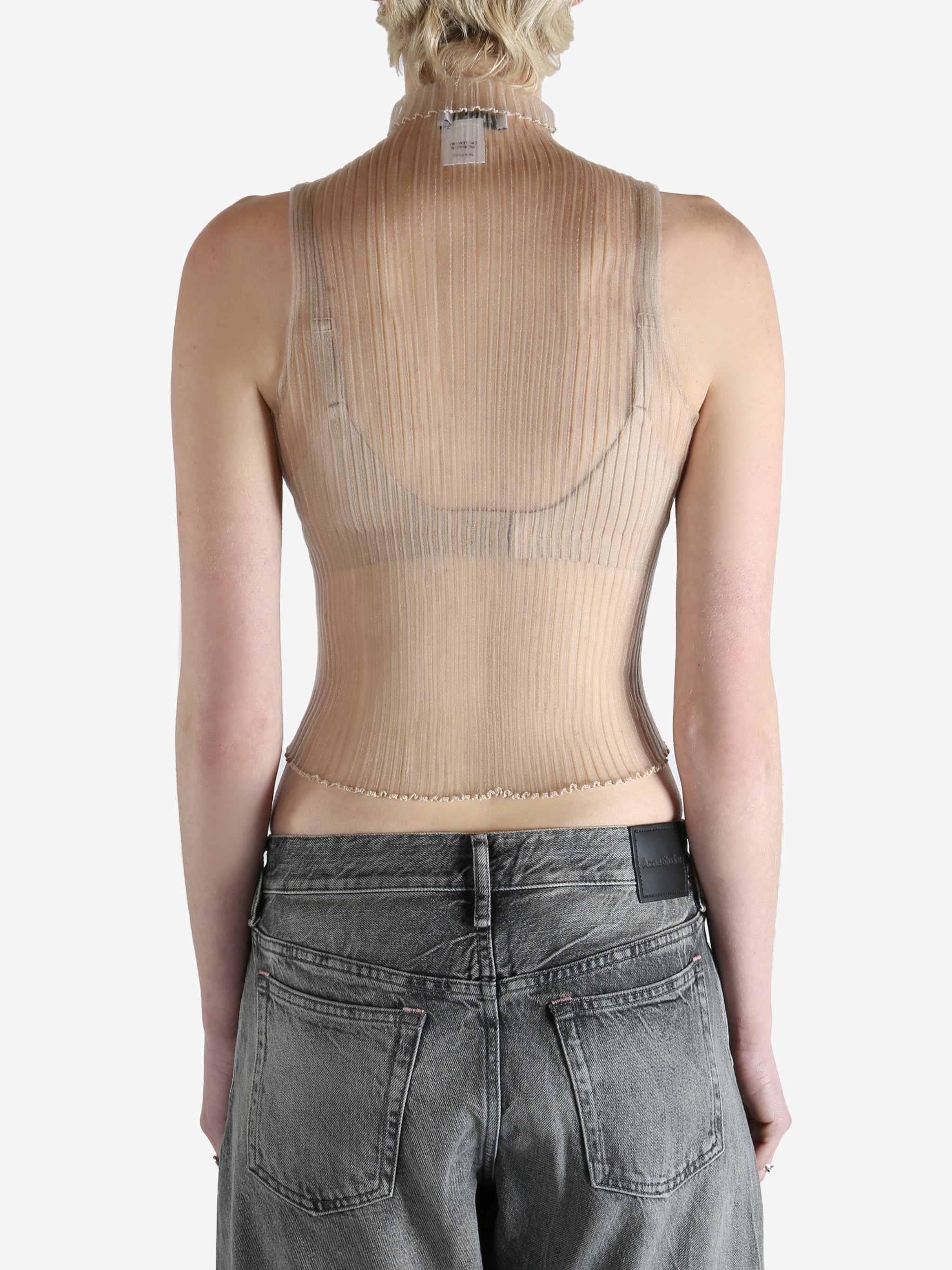 beige ribbed tank top worn by a person, showing the top fit