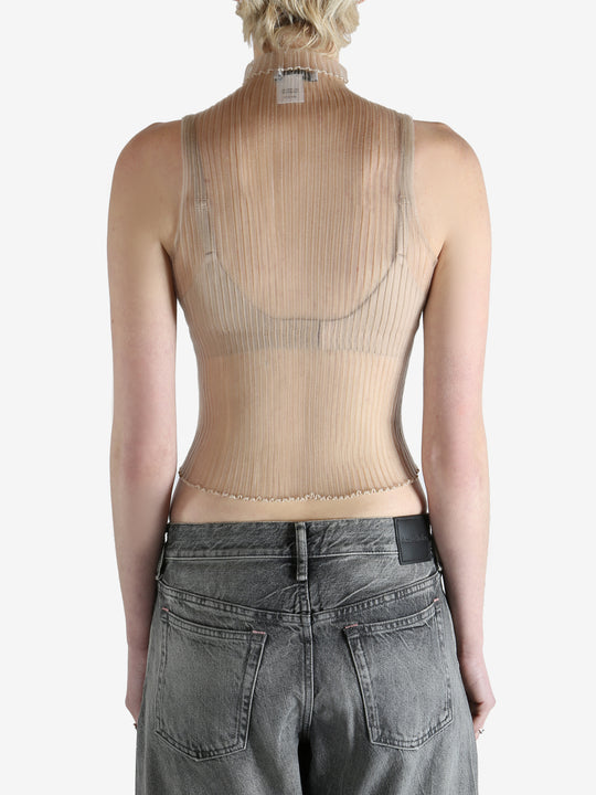 beige ribbed tank top worn by a person, showing the top fit