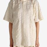 White shirt worn by a person, showing the shirt's fit