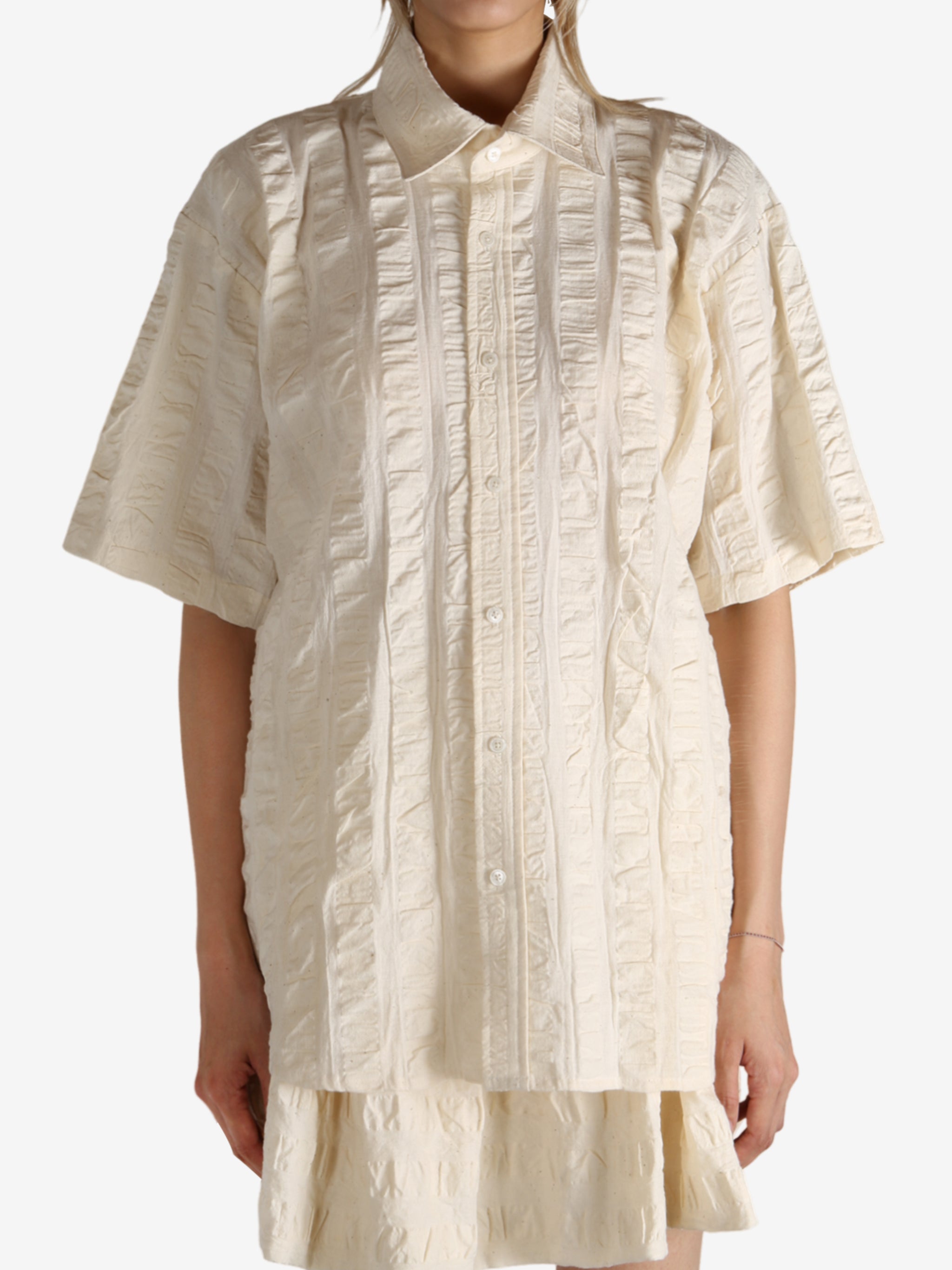 White shirt worn by a person, showing the shirt's fit