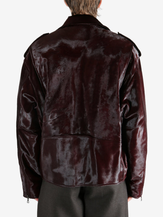 Brown jacket worn by a person, showing the jacket fit