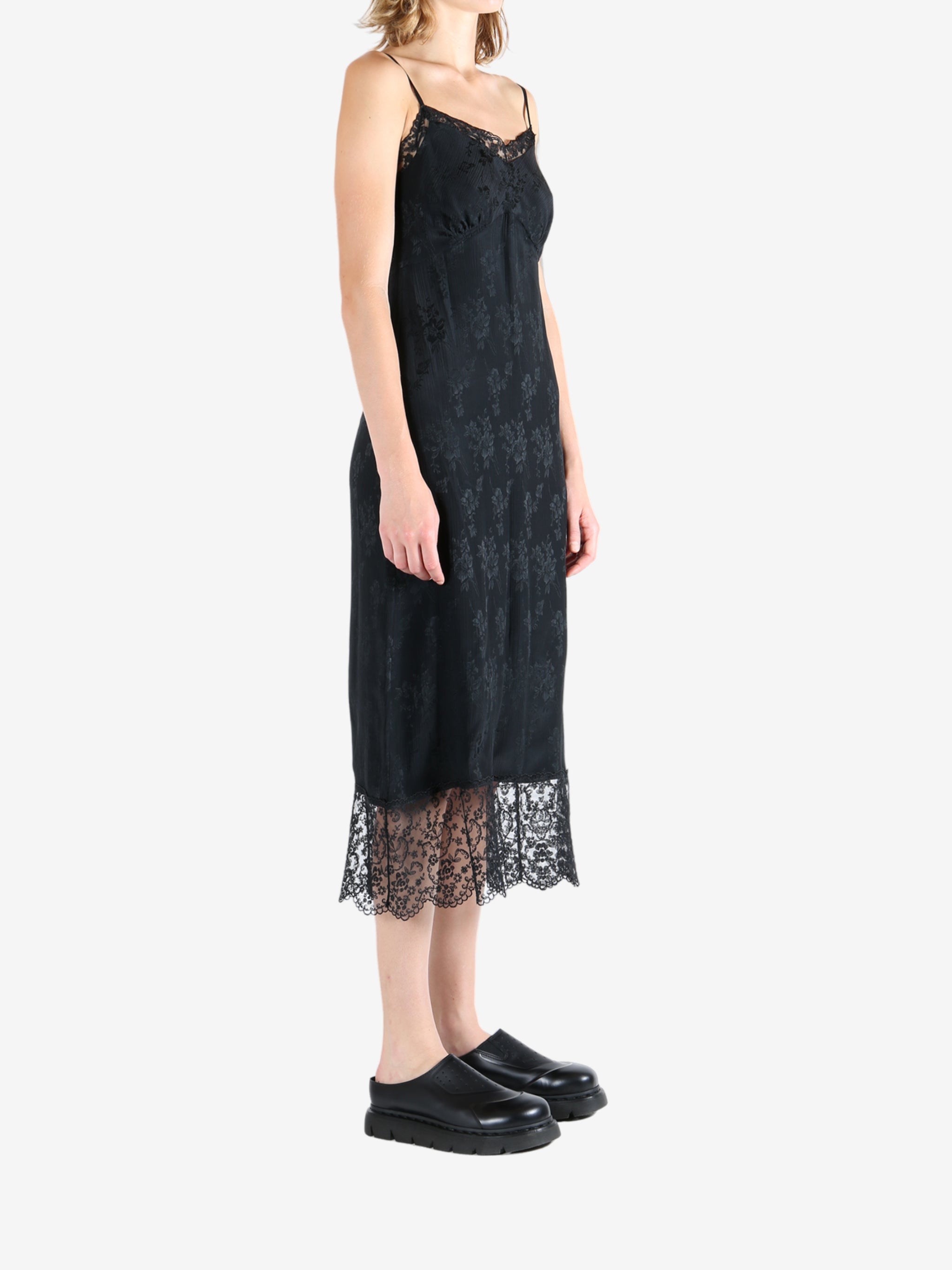 Black dress worn by a person, showing the dress's fit