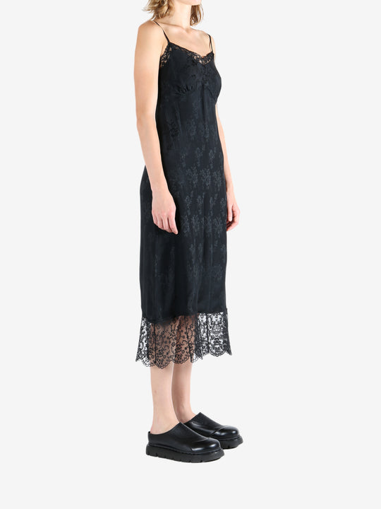 Black dress worn by a person, showing the dress's fit