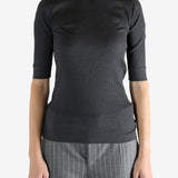 Grey tops worn by a person, showing the tops fit